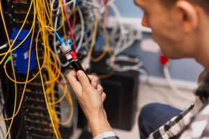 man testing optical fiber