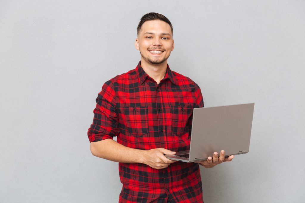 man holding laptop